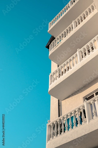 Fototapeta Beautiful balconies in a classic style flooded with sunlight.