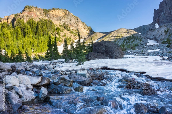 Obraz Volcanic mountain with patches of snow melting into raging streams of water runoff.
