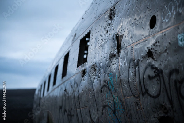 Fototapeta Close-up of fuselage of crashed aircraft at Solheimasandur in Iceland on a sad dark rainy day