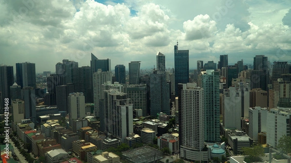 Fototapeta Manila city with skyscrapers, modern buildings and Makati business center. Travel vacation concept.