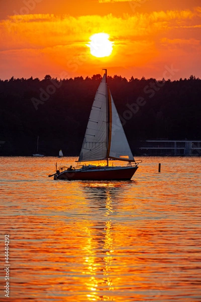 Obraz Sailboat in the background of the setting sun on the lake in Olsztyn - Warmia and Masuria, Poland, Europe