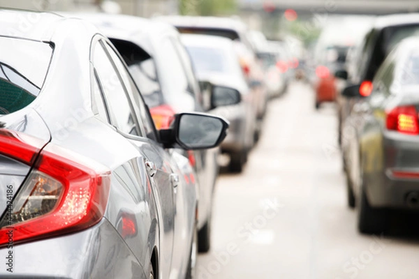 Fototapeta traffic jam in a city street road row of car on express way in rush hour. Traffic lights.  parking car. soft 