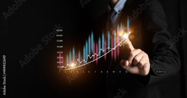 Fototapeta Businessman or trader is showing a growing virtual hologram stock, invest in trading. planning and strategy, Stock market, Business growth, progress or success concept.