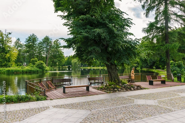 Fototapeta Promenade in Zwierzyniec, Lubelskie, Poland - with view on a big pond and park in city center