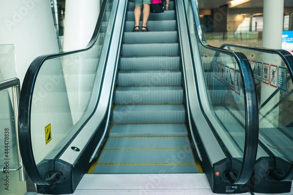 Fototapeta Airport Platov, Russia - 24.05.19: clean escalator closeup at the airport. beautiful modern escalator bottom-up view