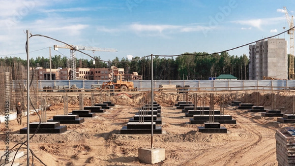Obraz Monolithic reinforced concrete foundations for the construction of a residential building. Grillage at the construction site. Construction pit with foundations.