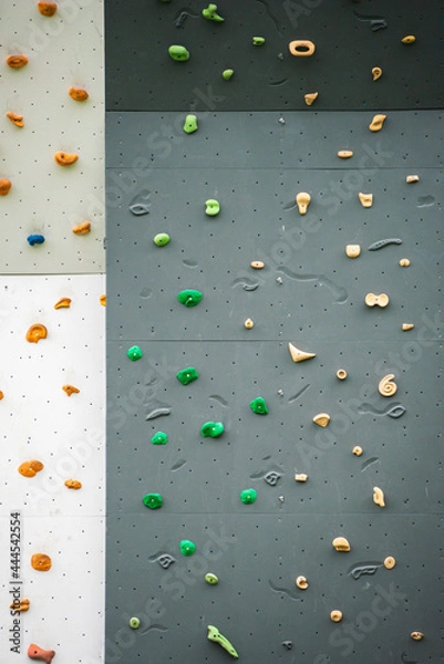 Obraz Abstract colorful of rock climbing wall with toe and hand hold studs, various colored grips at outdoor gym adventure park.