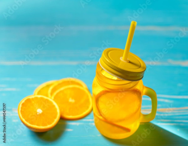 Fototapeta Cold drink with oranges in jar