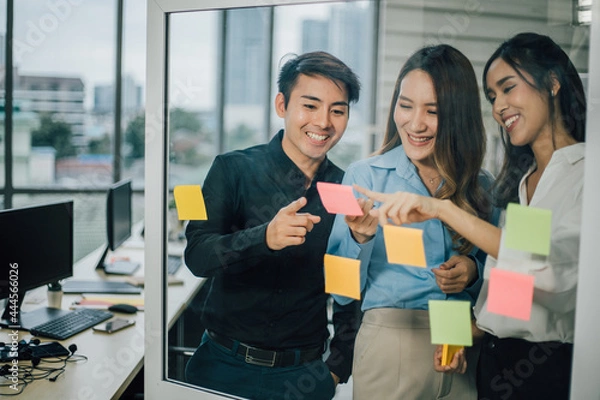 Obraz Young asian officer team discussing and planing project together with organization management.