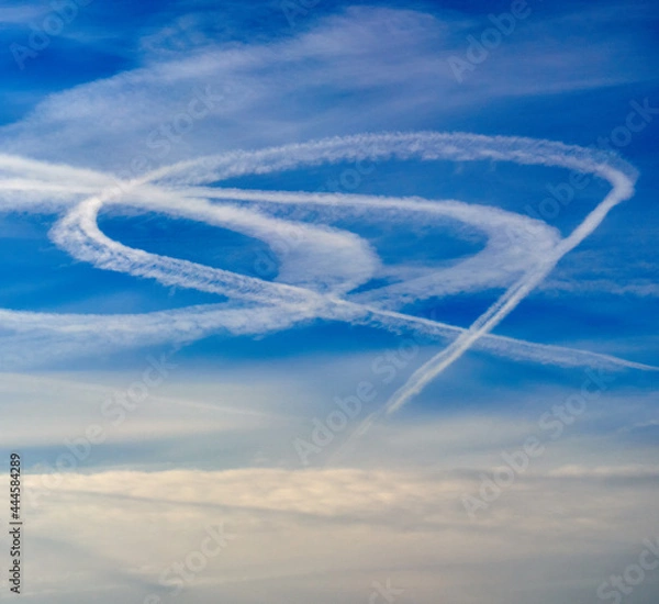 Obraz Airplane trails in the blue summer sky. Abstract nature background.