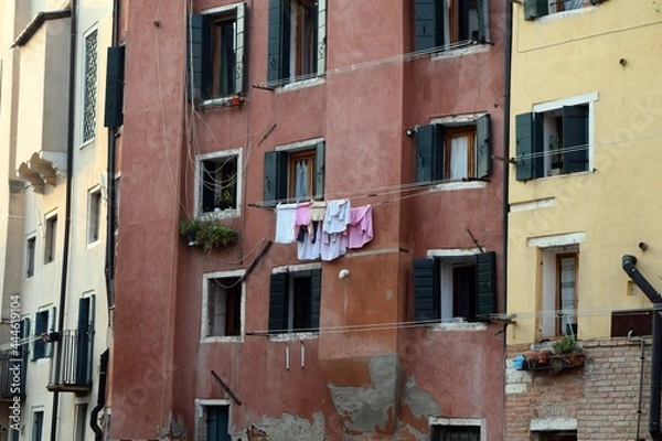 Fototapeta Laundry hanging on a string between two windows in a building in Venice.