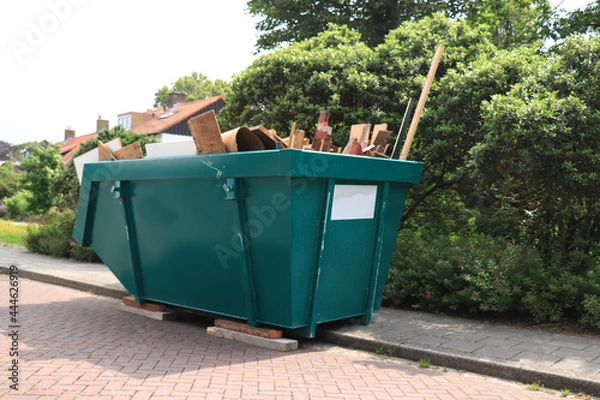 Fototapeta Loaded garbage dumpster