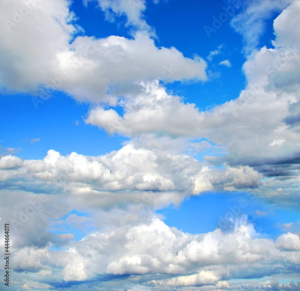 Fototapeta Blue sky with scenic cumulonimbus clouds. Natural blue background with clouds.