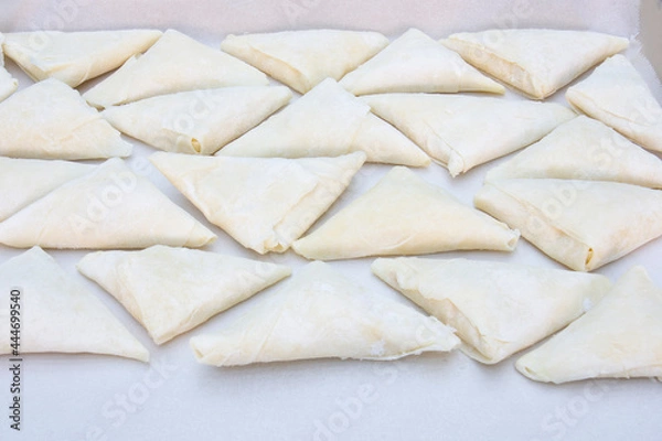 Fototapeta A ready-to-bake patty folded into a triangle.