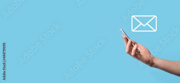 Fototapeta Male hand holding letter icon,email icons .Contact us by newsletter email and protect your personal information from spam mail. Customer service call center contact us.Email marketing and newsletter