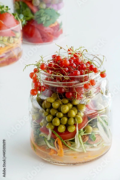 Obraz A snack of raw vegetables in a glass. Bright vegetables on a white background