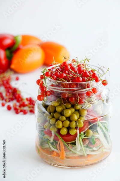 Obraz A snack of raw vegetables in a glass. Bright vegetables on a white background
