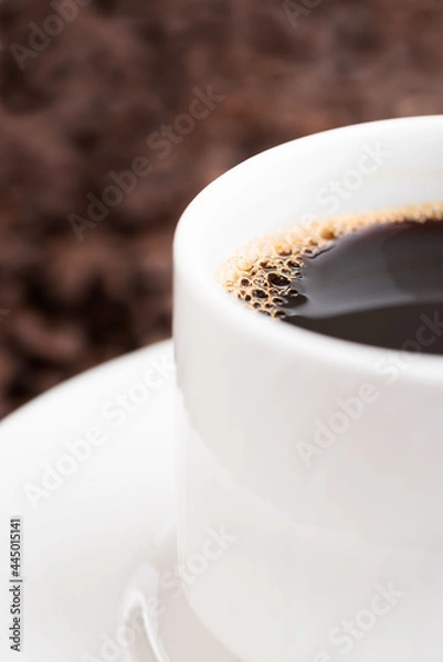 Obraz Coffee mug isolated on coffee background