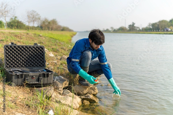 Obraz Technician use the Professional Water Testing equipment to measure the water quality at the public canal. Water quality monitoring concept.
