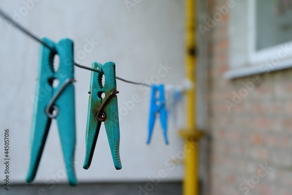 Obraz close-up of blue clothespin with rusted metal clip