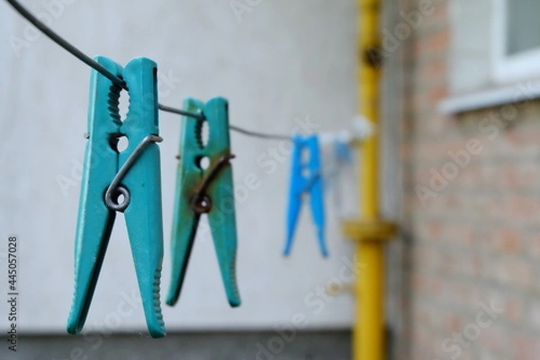 Obraz close-up of blue clothespin with metal clip
