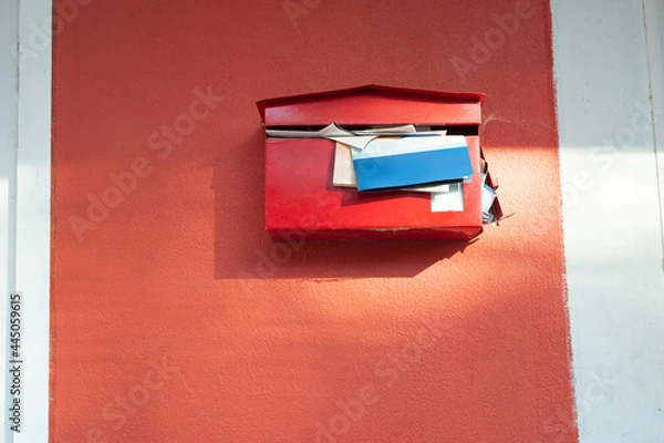 Obraz red mailbox with documents overflowing