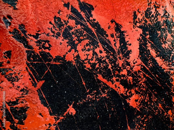 Fototapeta Spilled paint on the asphalt. Grunge texture with splashes and stones. Dark background with bright spots