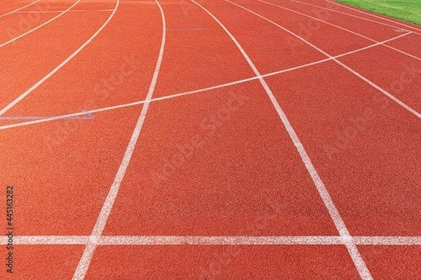 Fototapeta The curved lane in running track or athlete track in stadium. Running track is a rubberized artificial running surface for track and field athletics