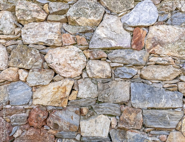 Obraz rough various colored stone wall closeup, seamless natural background