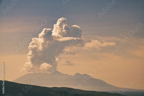 Fototapeta huge white clouds over the mountains and sea
