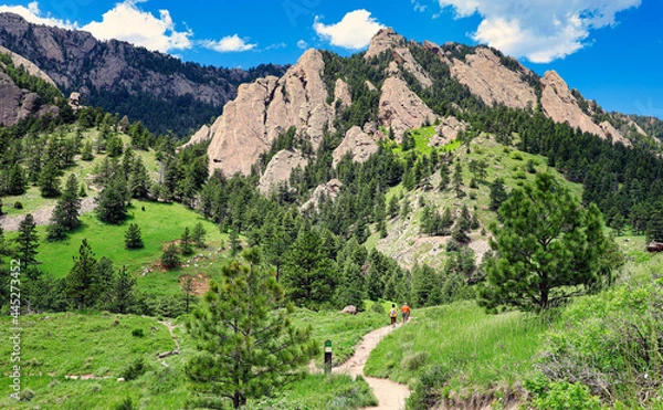 Fototapeta Hikers approach the Rocky Mountain foothills near Boulder, Colorado