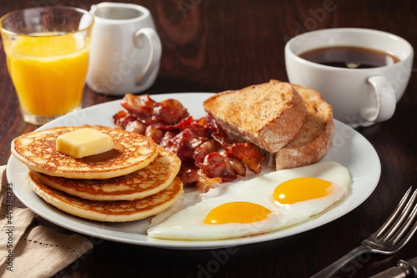 Fototapeta traditional full american breakfast eggs pancakes with bacon and toast