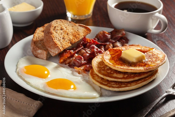 Fototapeta traditional full american breakfast eggs pancakes with bacon and toast