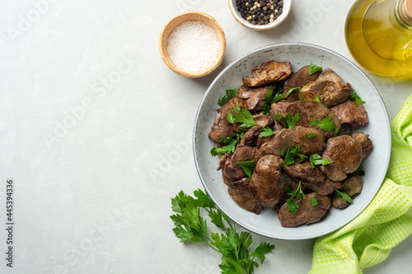 Fototapeta Fried chicken liver with parsley in plate on concrete background