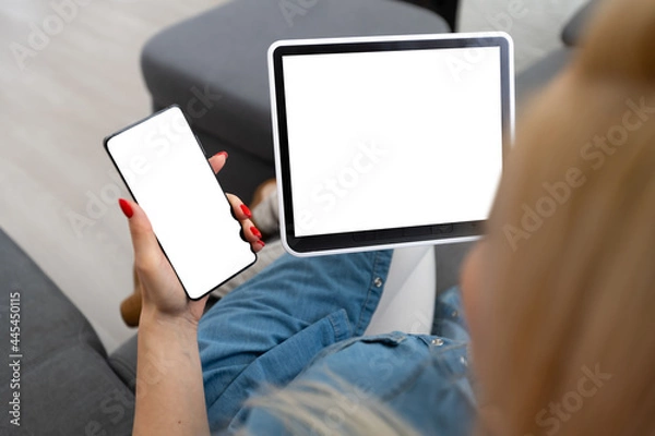 Fototapeta Intelligent home concept. Young woman using smart home application on a tablet