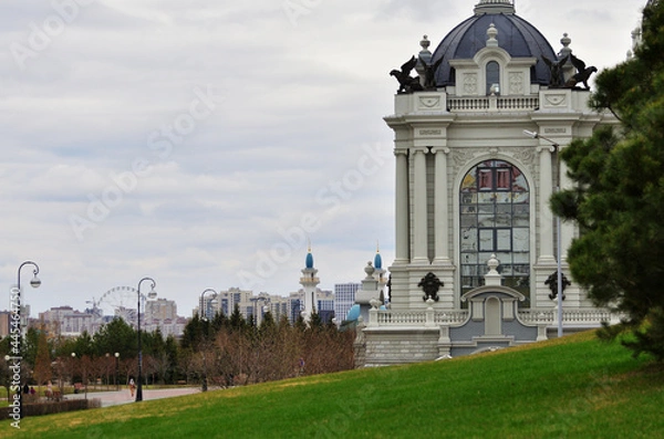 Fototapeta View from the side of the building of the Palace of landowners against the background of the mosque on a cloudy day. Russia Kazan 24.04.2021. High quality photo