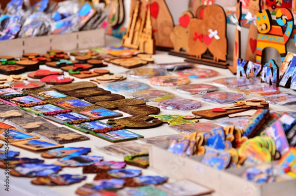 Fototapeta A counter with wooden souvenir magnets with city attractions for tourists. Russia Kazan 24.04.2021. High quality photo