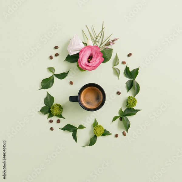 Obraz Espresso coffee cup with coffee beans and beautiful flowers with foliage on a pastel green background