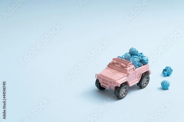 Obraz Cute pale pink toy truck delivering popcorns on a pastel blue background minimal with copyspace