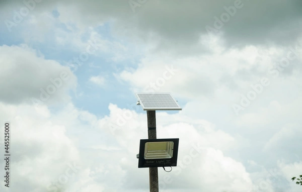 Obraz Street lighting pole with photovoltaic panel and LED lamp lights.