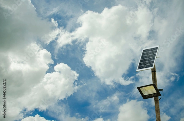 Obraz Street lighting pole with photovoltaic panel and LED lamp lights.
