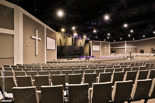 Fototapeta Empty interior of large church congregation sanctuary with stage and concert seating