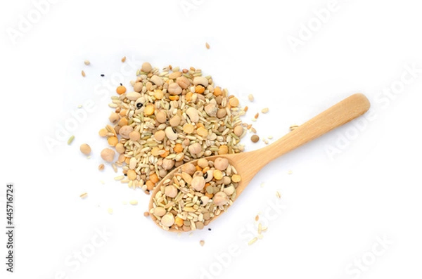Obraz Mixed dry organic cereal and grain seed pile and wooden spoon in soft brown tone on white background