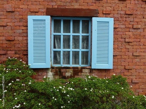 Obraz Blue window on red brick wall