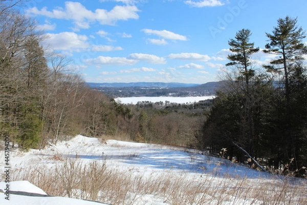 Obraz Stockbridge Bowl, also known as Lake Mahkeenac, in Massachusetts in winter with snow on the ground seen from a viewpoint known as "Olivia's Overlook"