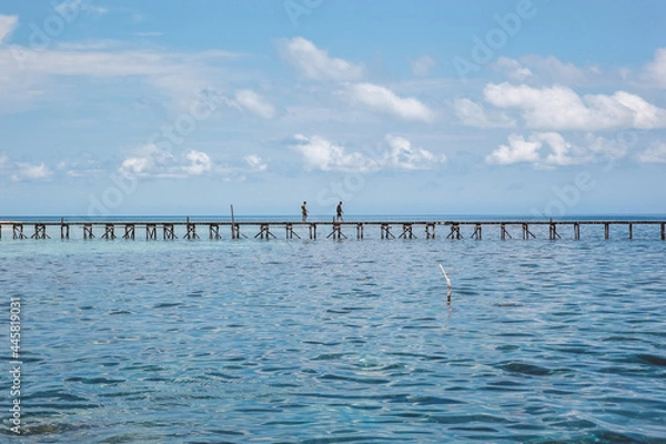 Fototapeta People Walking on the wooden bridge in the middle of ocean at Karimun Jawa