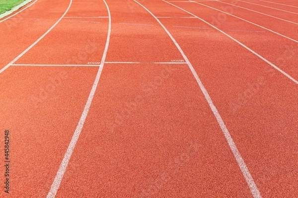 Fototapeta The curved lane in running track or athlete track in stadium. Running track is a rubberized artificial running surface for track and field athletics