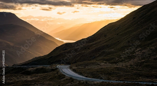Fototapeta The beautiful road between Queenstown and Wanaka via Crown range. Grassland and beautiful landscape of rocky mountains.