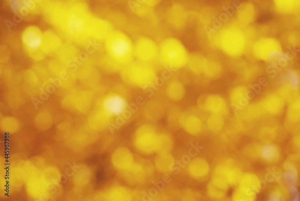 Fototapeta Golden colored blurred background. Abstract background with bokeh.
