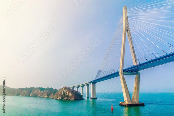 Fototapeta MOKPO, KOREA, SOUTH - Apr 02, 2016: Mokpo Bridge over the sea under the sunlight and a blue sky in South Korea